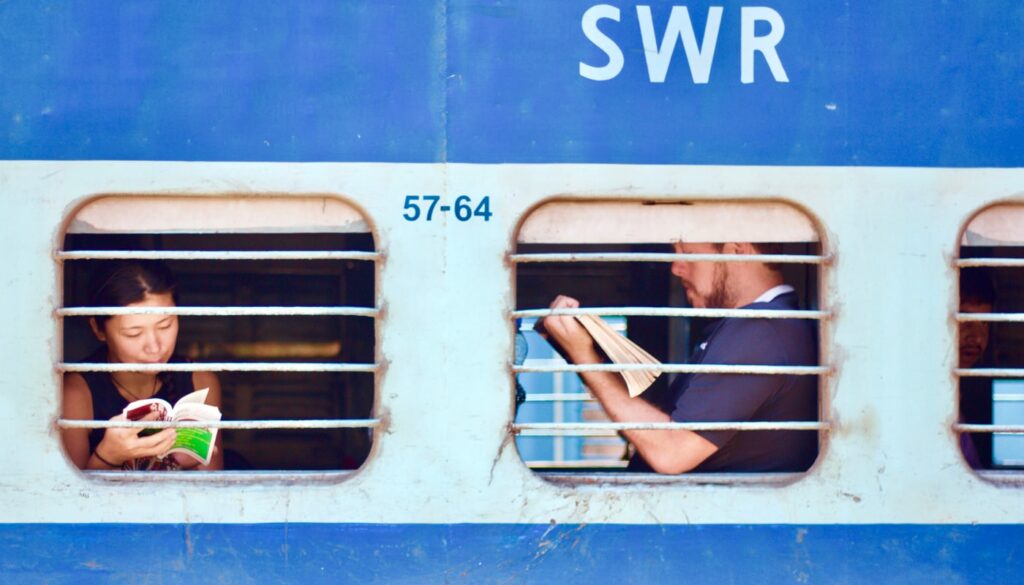 man and woman sitting on train